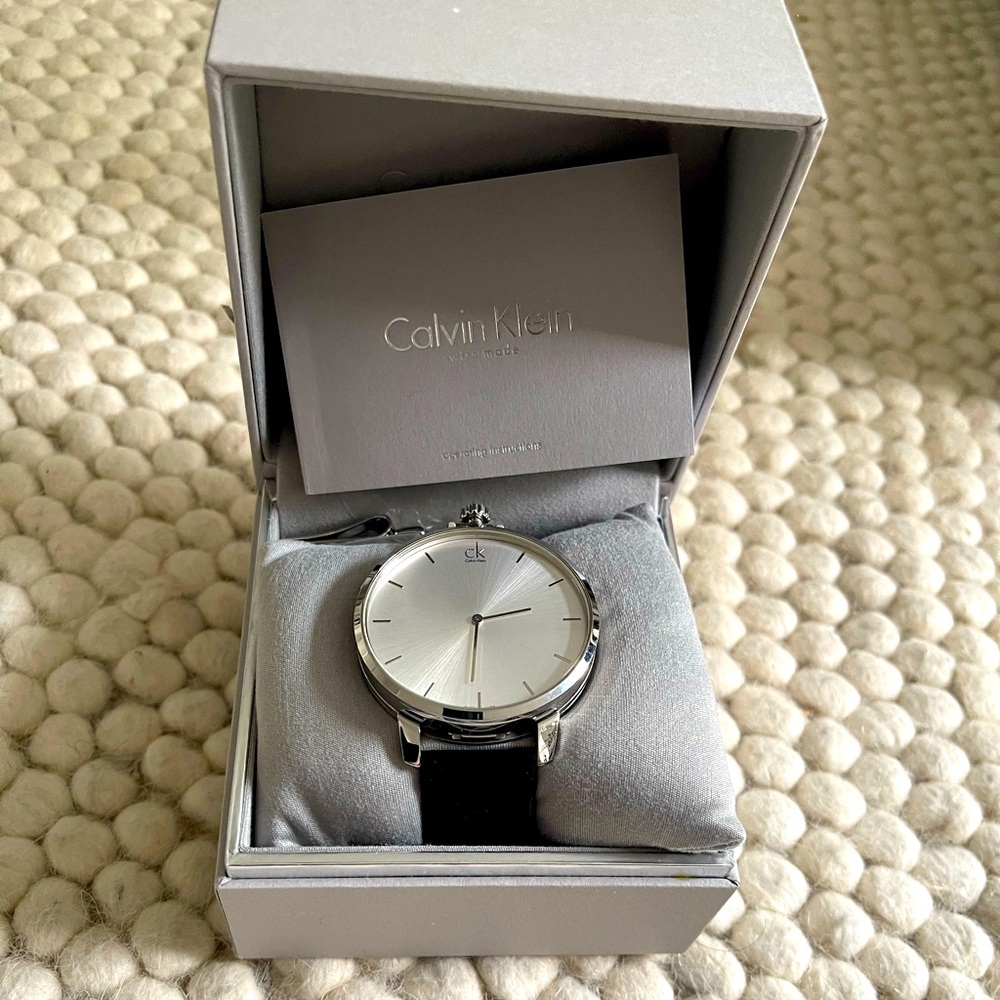 Brand new Calvin Klein men watch, silver display and black leather strap